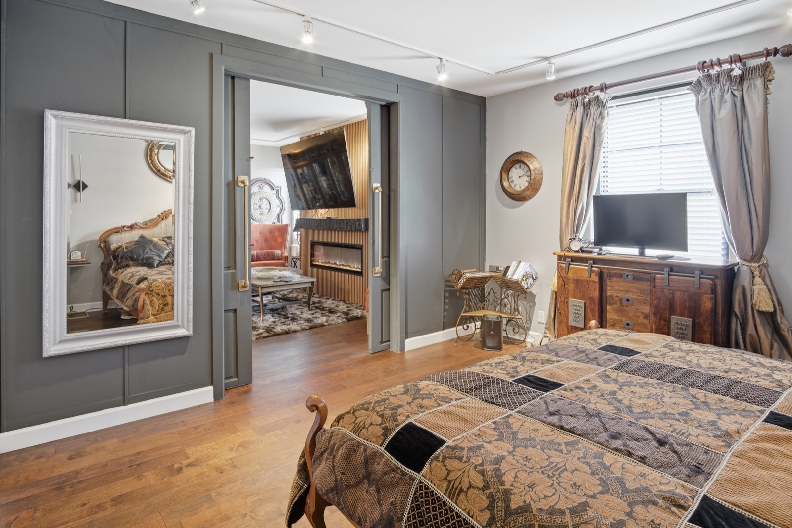 Bedroom with paneled walls and mirror