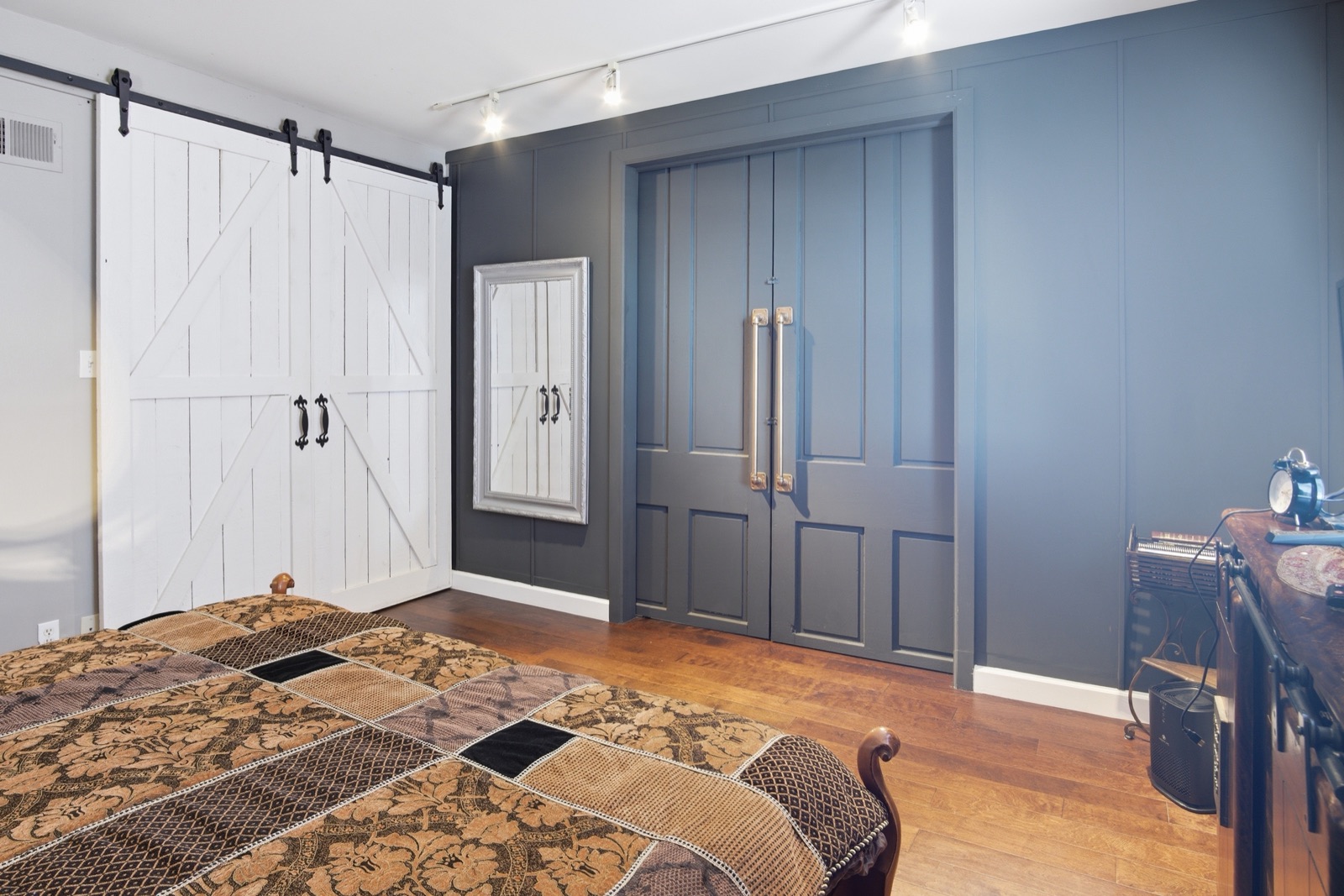 Gray paneled closet wall and white barn doors