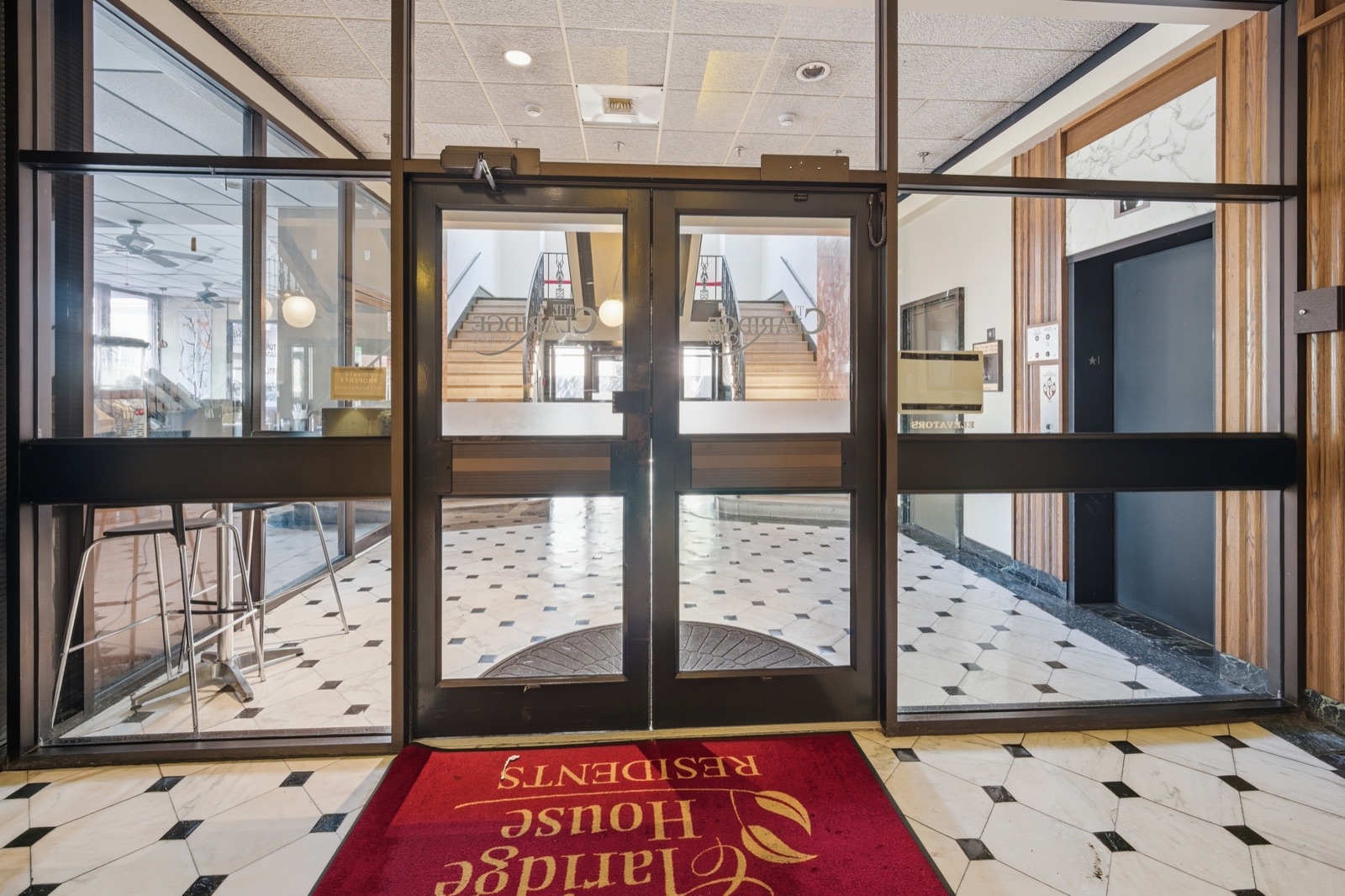 Residents' entrance doors with Claridge House rug