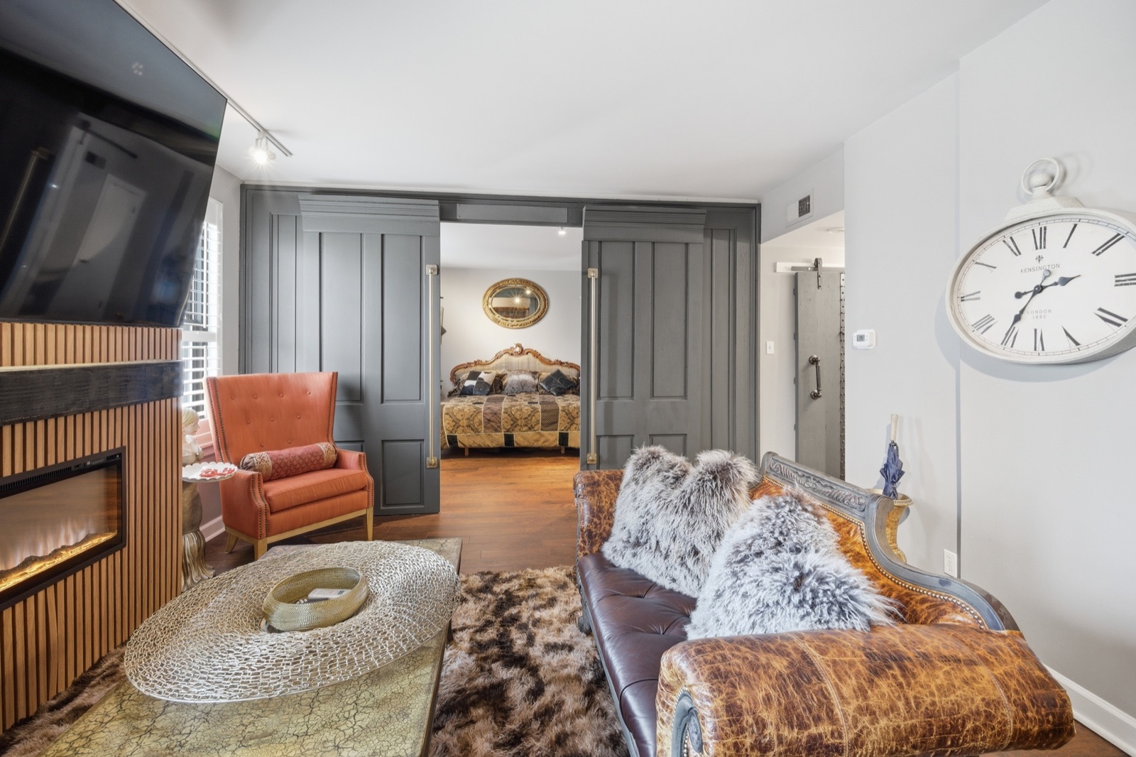 Living room with paneled sliding doors to bedroom